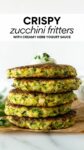 stacked zucchini fritters topped with yogurt sauce with text overlay.