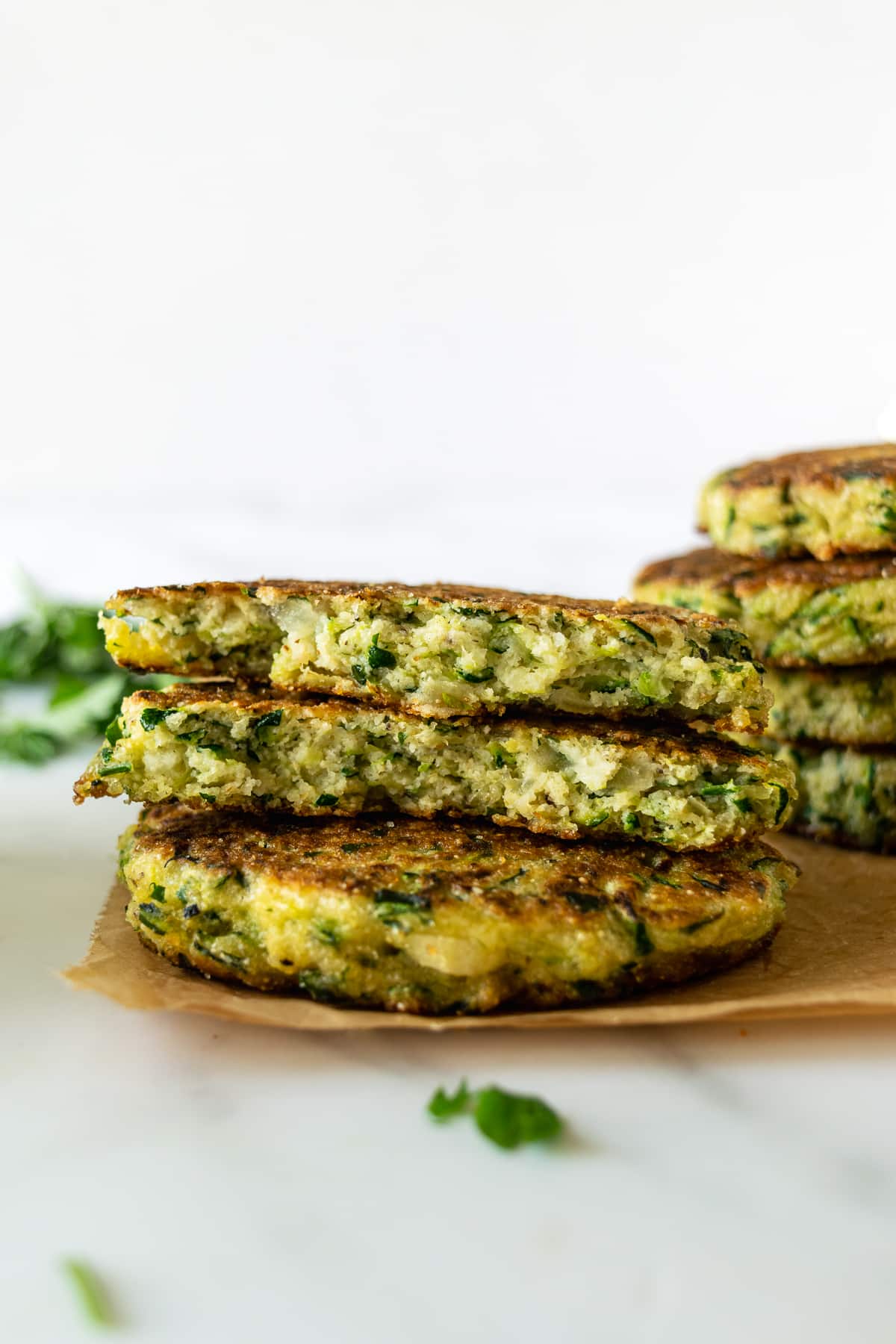 stacked cut in half zucchini fritters.