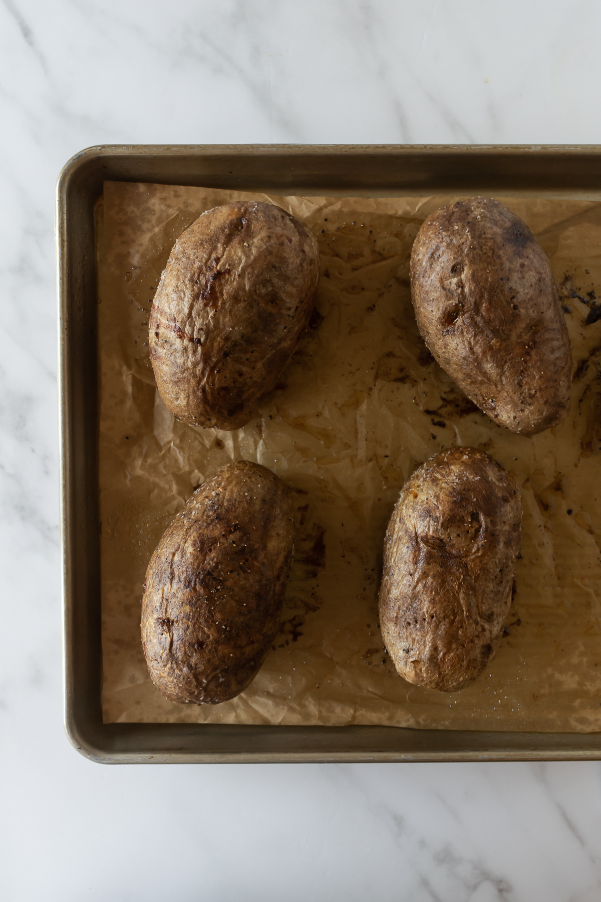 baked potatoes on a baking sheet lined with parchment paper.