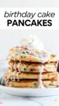 a stack of pancakes topped with vanilla glaze, sprinkles, and whipped cream with a fork with overlay text.