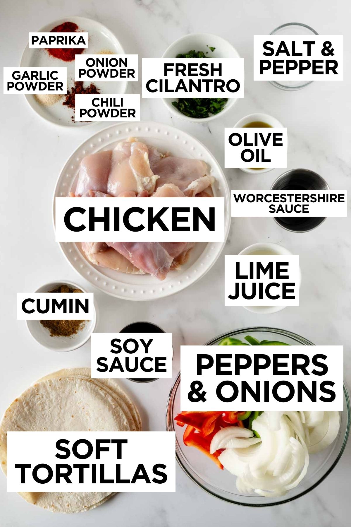 chicken fajita recipe ingredients in bowls on a white table.