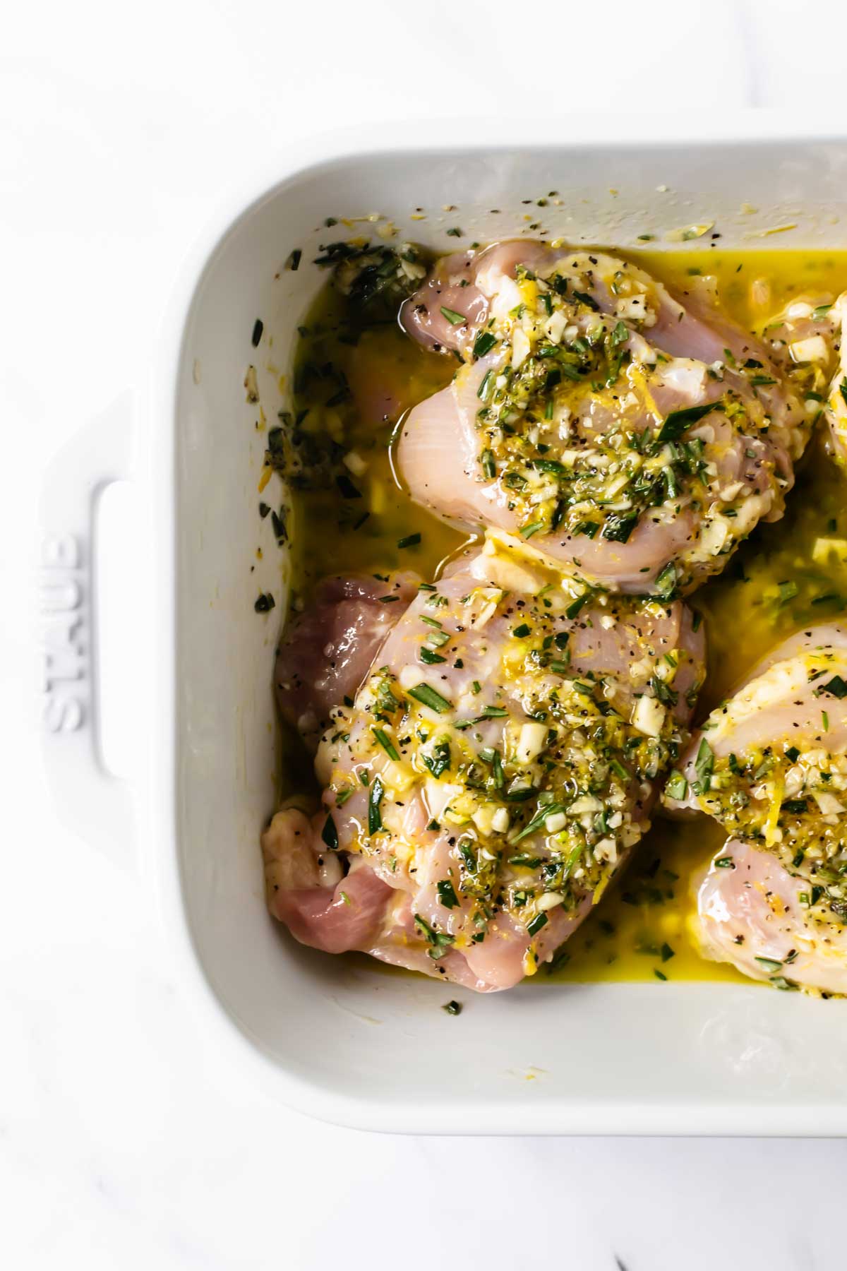 lemon rosemary chicken marinade in a white baking dish.