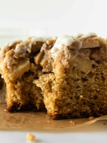 apple crumb cake with a bite taken from it.