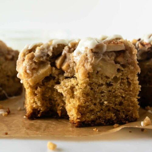 apple crumb cake with a bite taken from it.