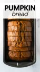 slices of baked pumpkin bread in a loaf pan with overlay text "pumpkin bread".