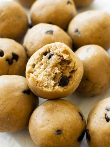 a bite taken from cookie dough protein balls with chocolate chips.