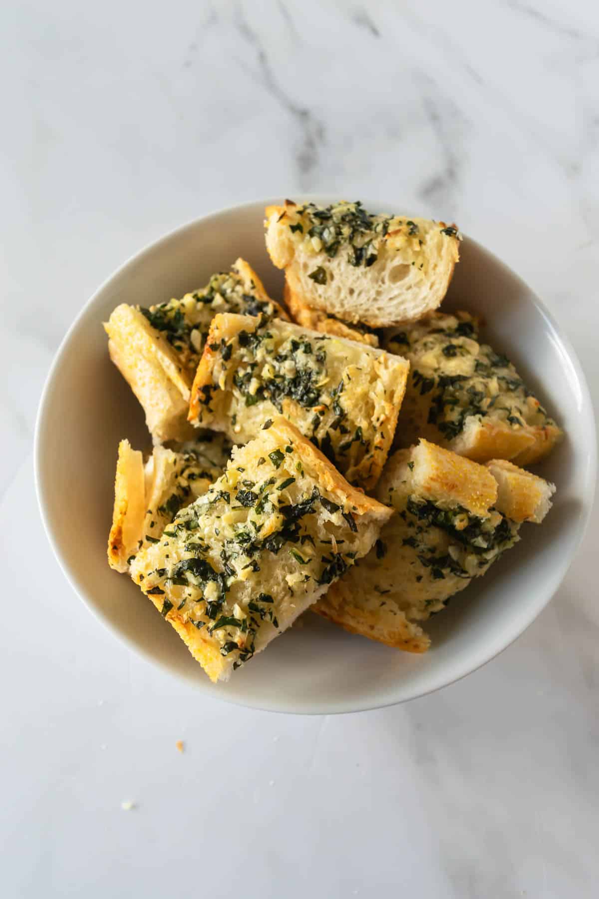 garlic bread slices in a white bowl.