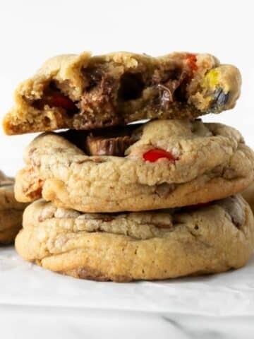 three stacked Halloween candy cookies on a white table.