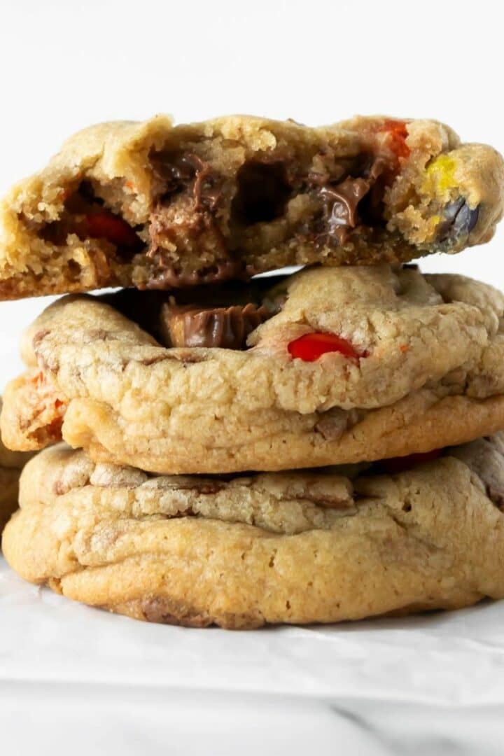 three stacked Halloween candy cookies on a white table.
