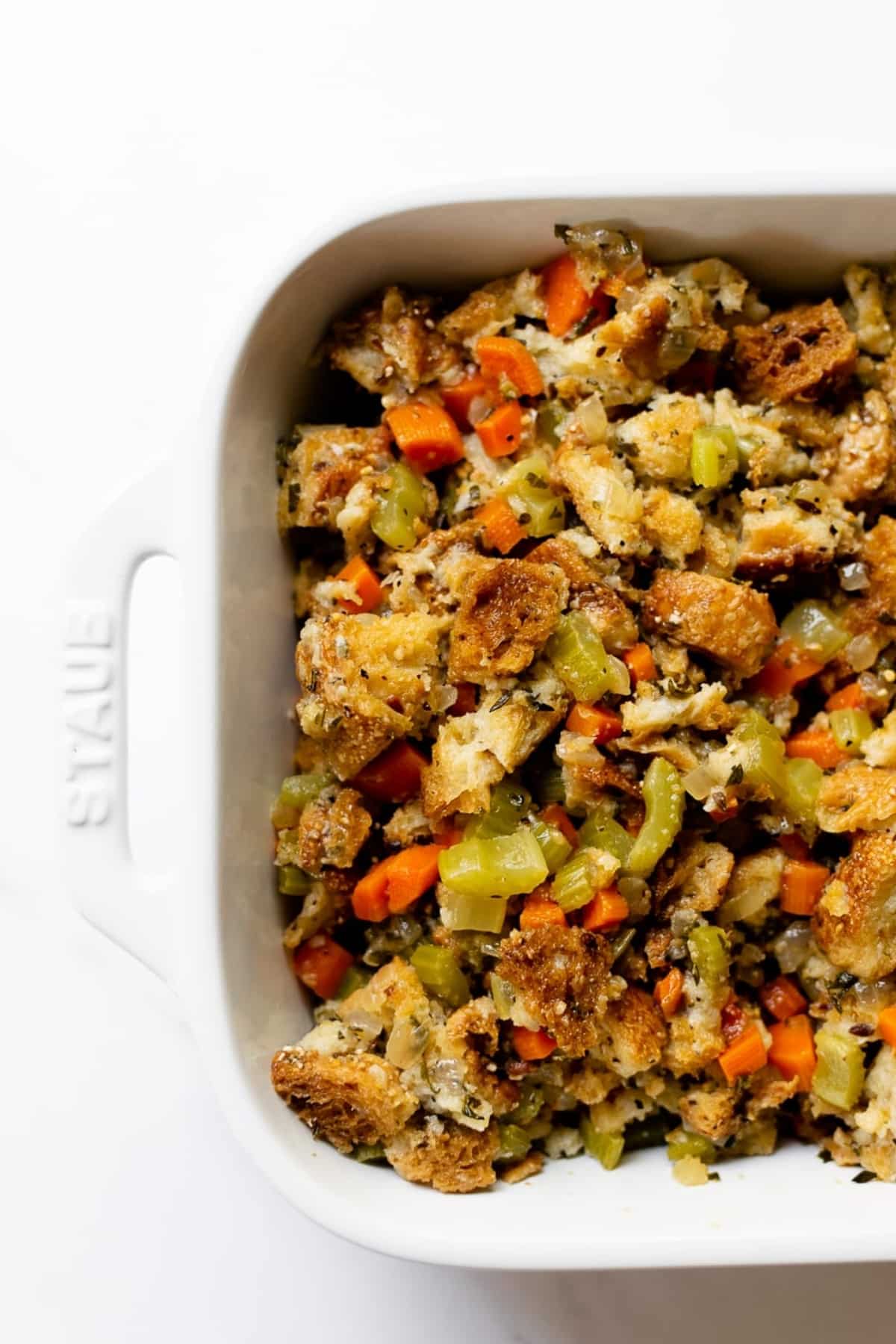 herb stuffing in a white baking dish.