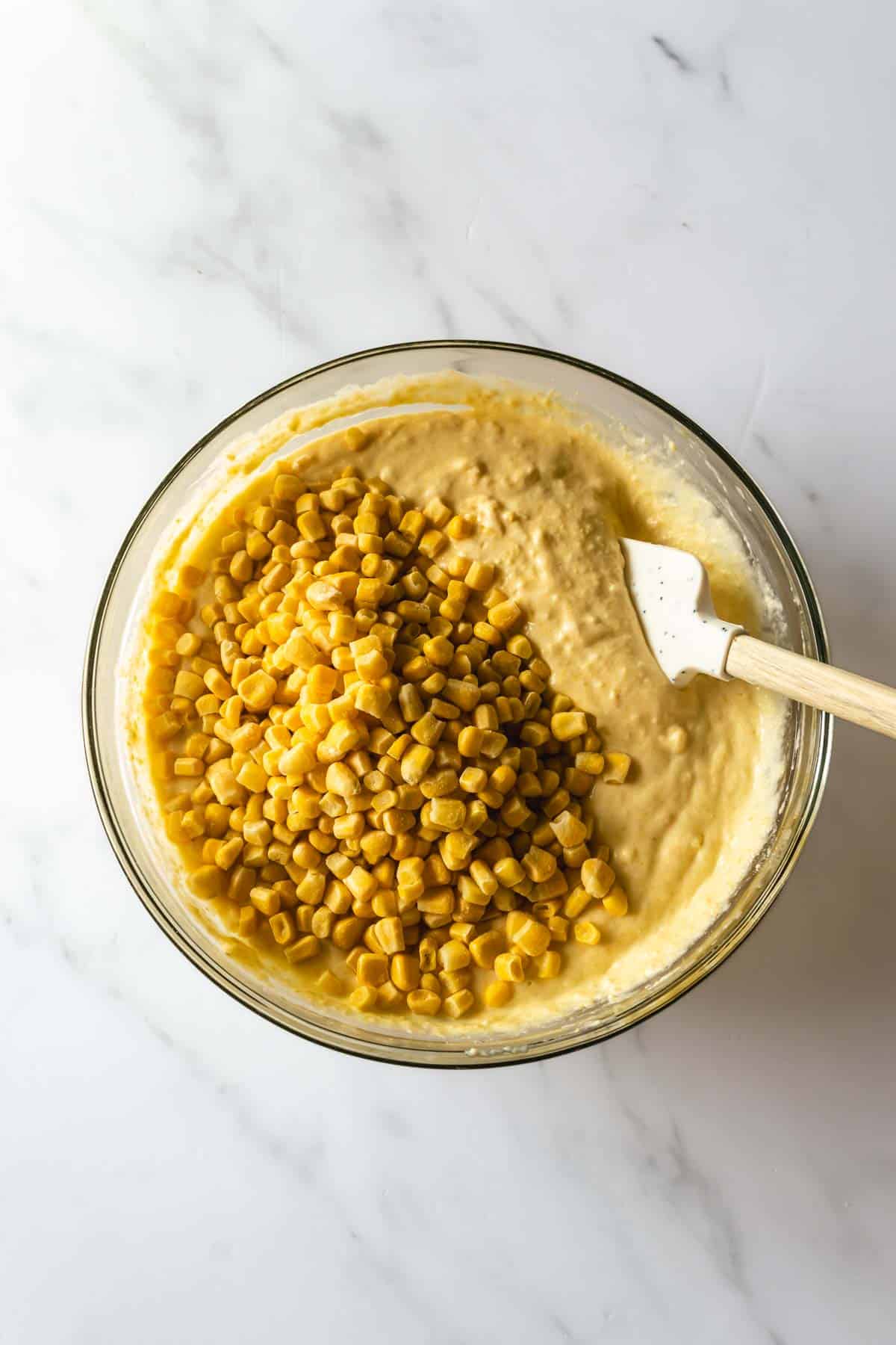 corn casserole batter with corn kernels in a bowl.