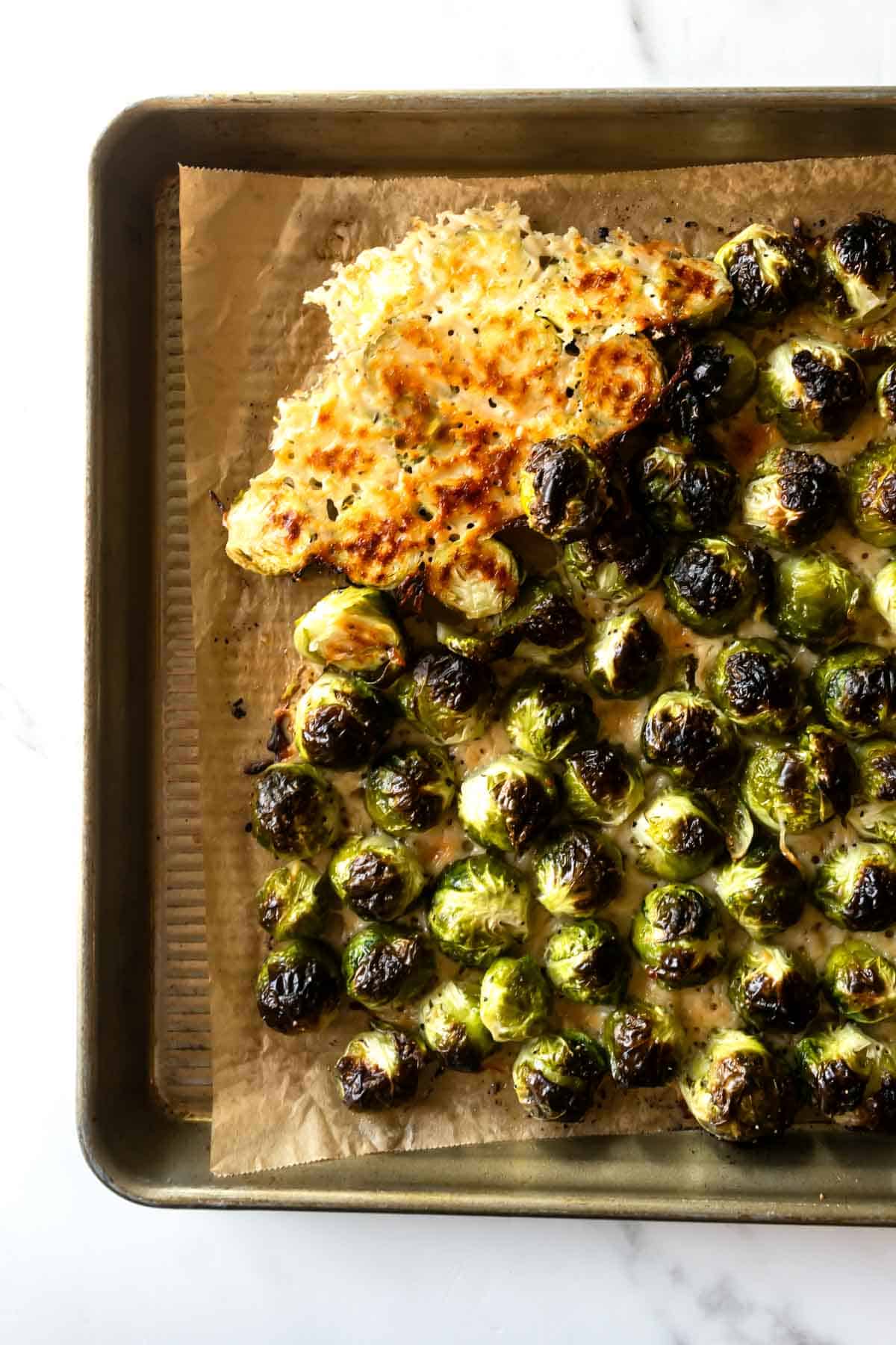 brussels sprouts on a baking sheet with parmesan cheese.