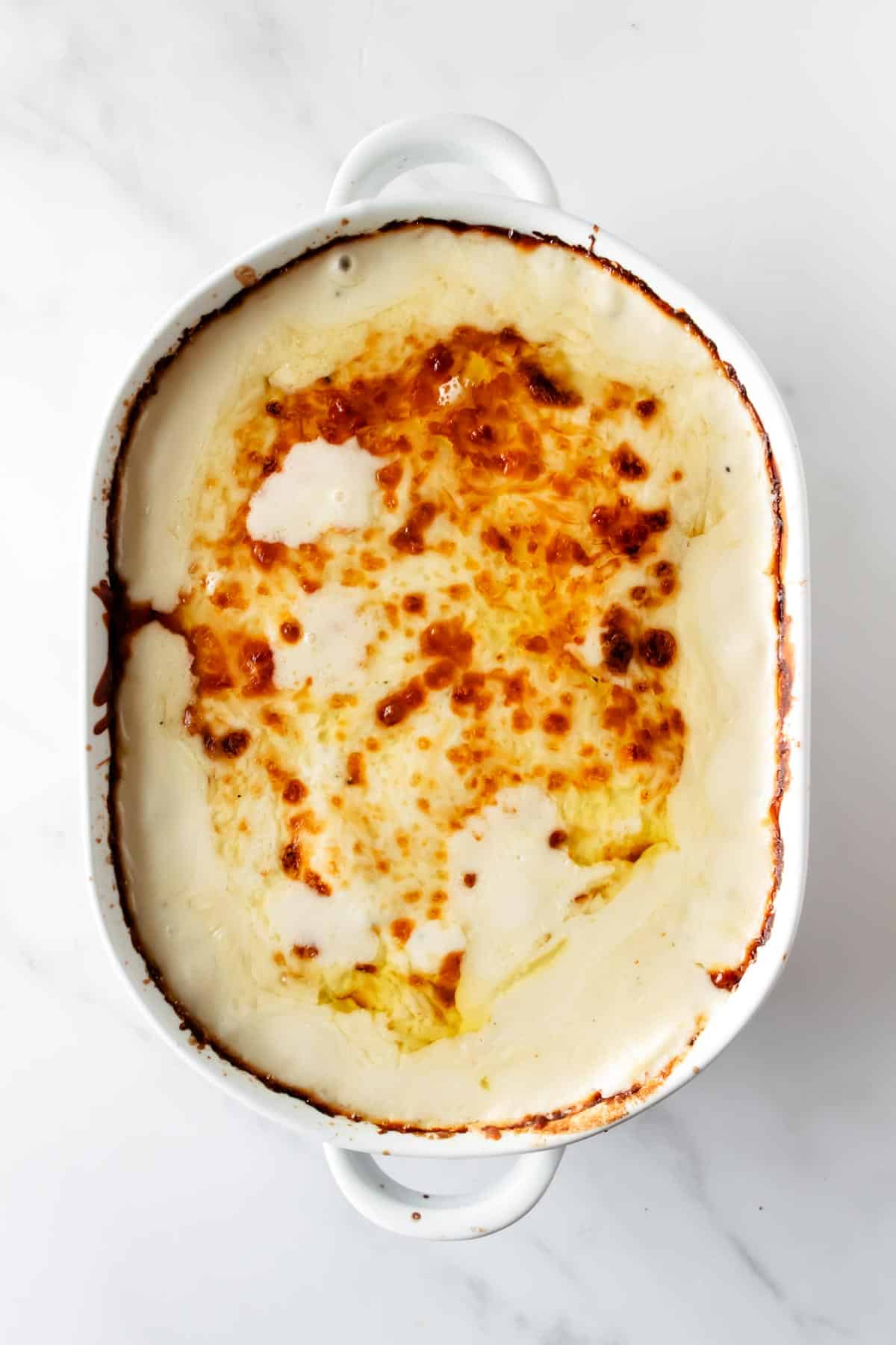 cooked scalloped potatoes in a baking dish.