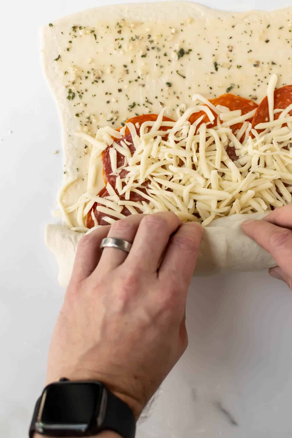 rolling up a stromboli.