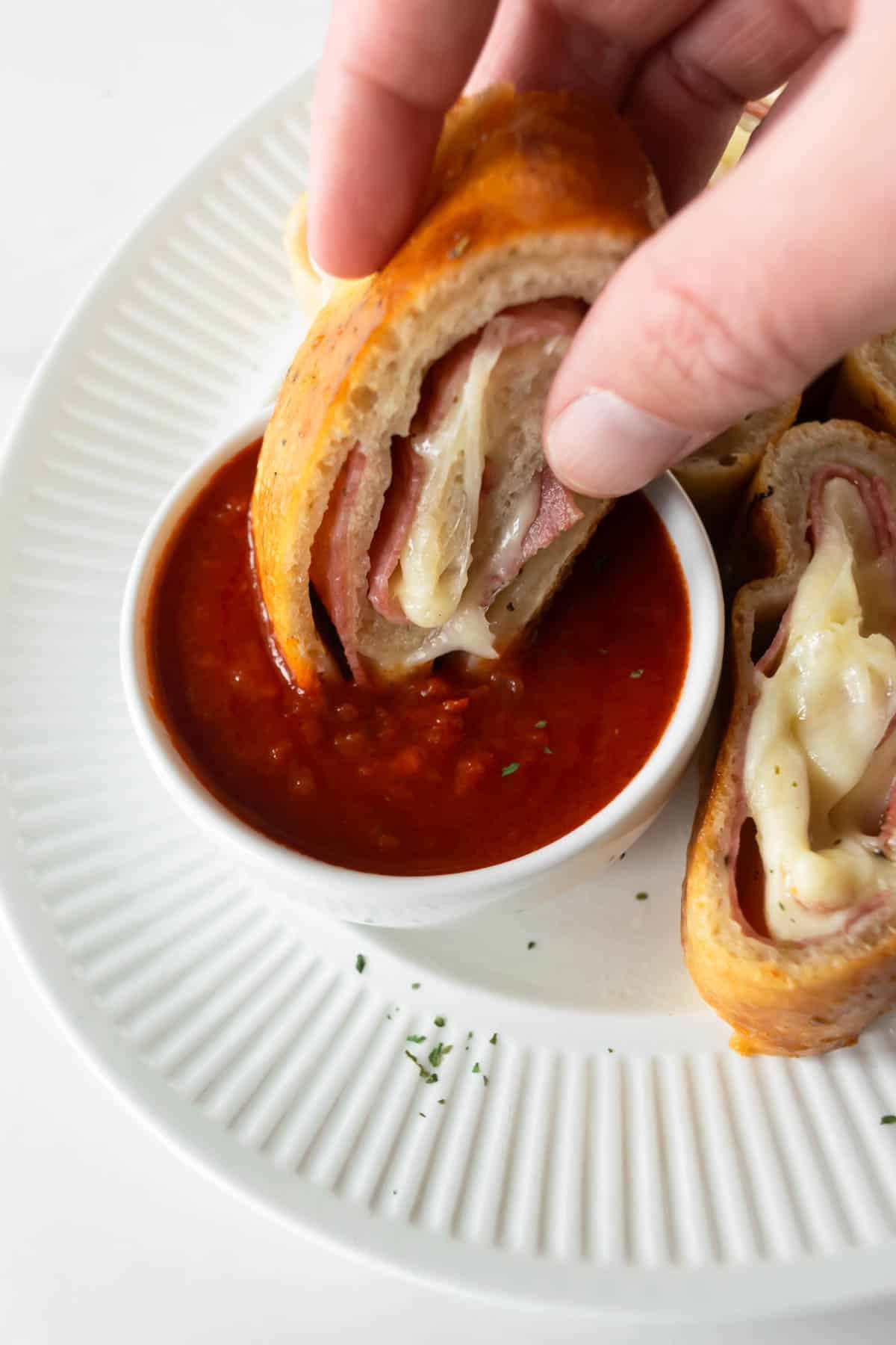 dipping stromboli in marinara sauce.