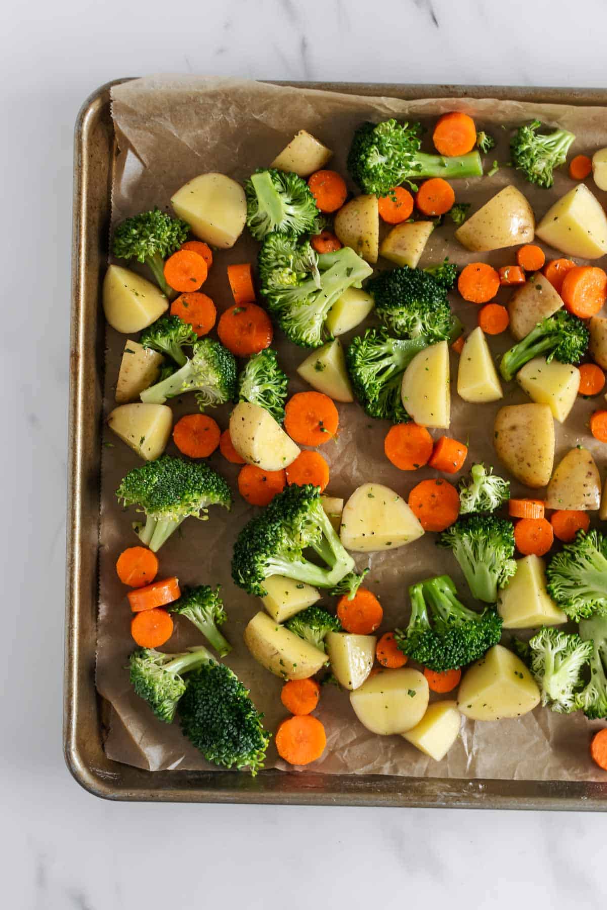 vegetables and potatoes on a baking sheet.