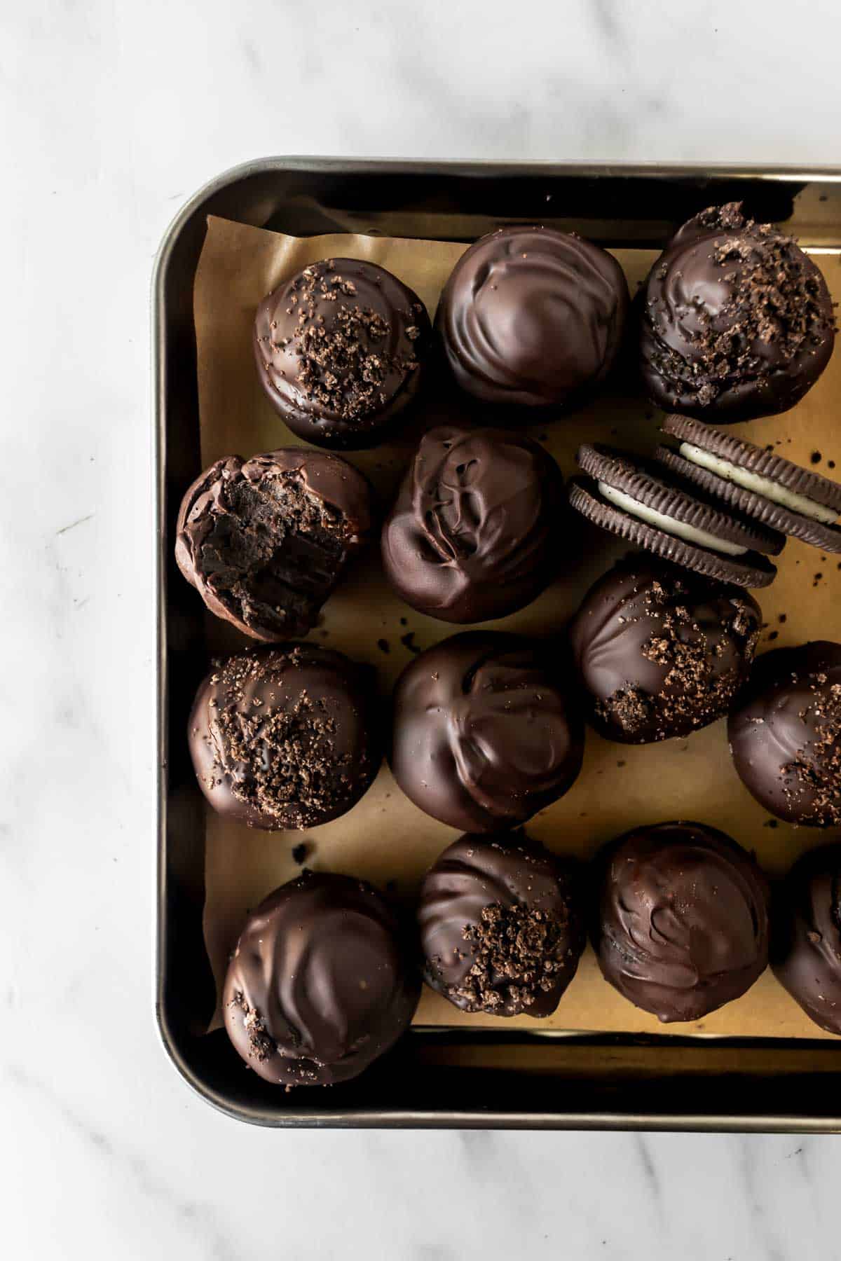 Oreo balls on a baking sheet.