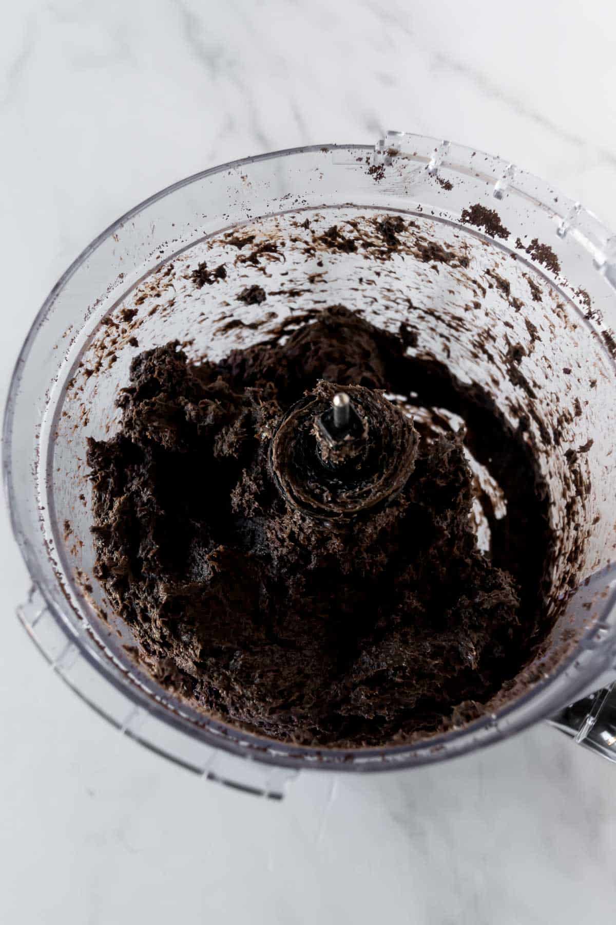 Oreo truffle dough in a food processor.