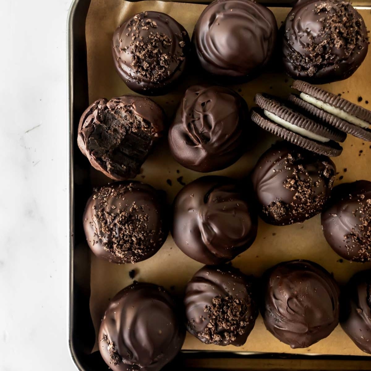 Oreo balls on a baking sheet.