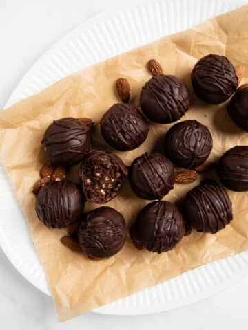 chocolate almond truffles on a white plate.