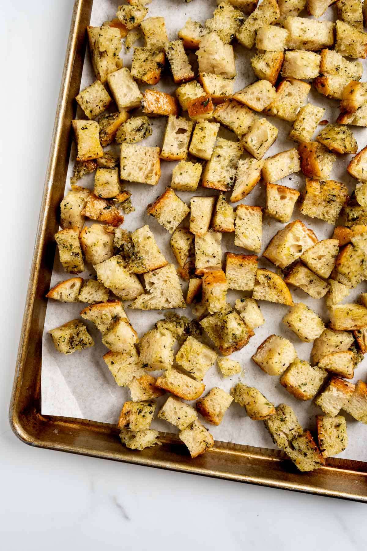 pre-baked homemade croutons on a baking sheet.