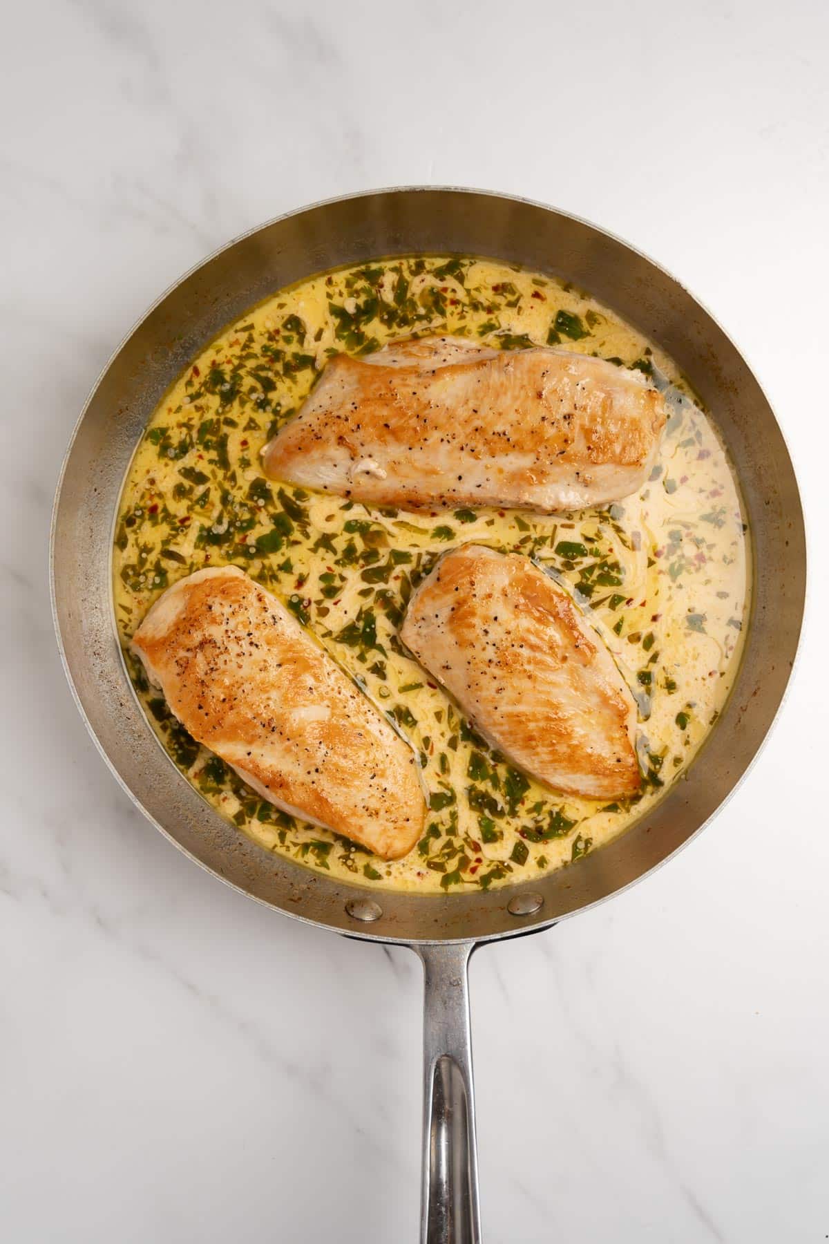3 pieces of chicken in a cilantro lime sauce.