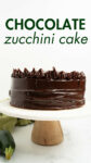 frosted chocolate zucchini cake on a cake stand with overlay text.