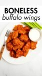 boneless buffalo wings on a platter with celery and blue cheese with overlay text.