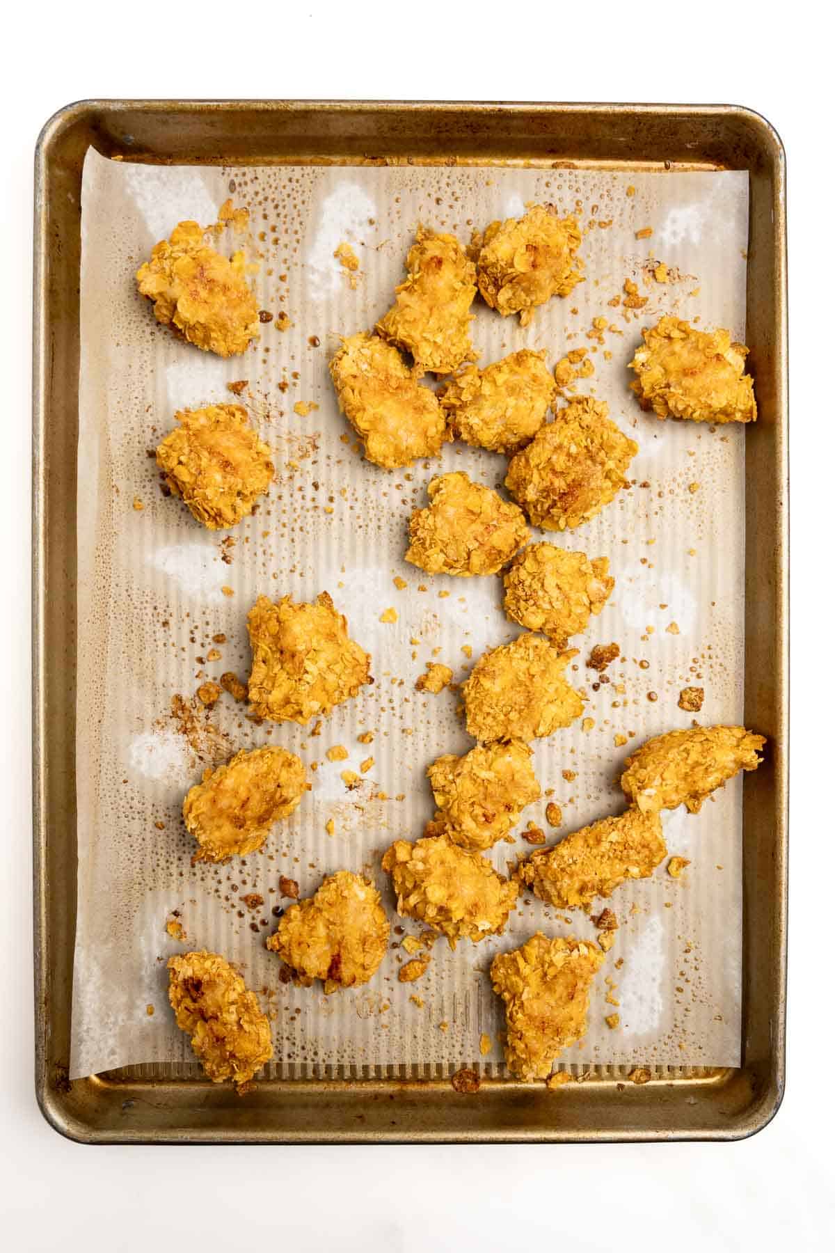 baked boneless buffalo chicken bites on a baking sheet.