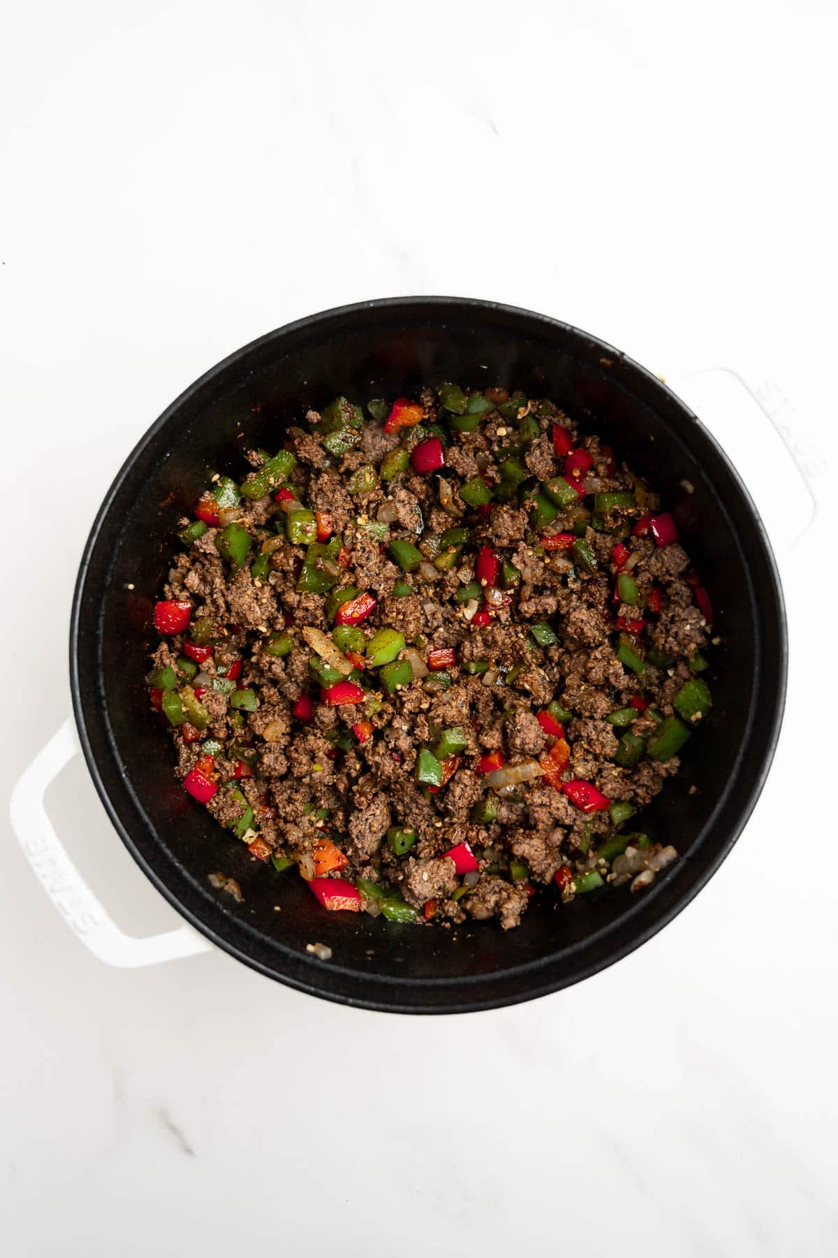 ground beef and peppers in a dutch oven.