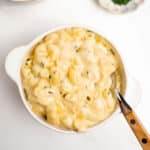 homemade mac and cheese in a white bowl with a fork.