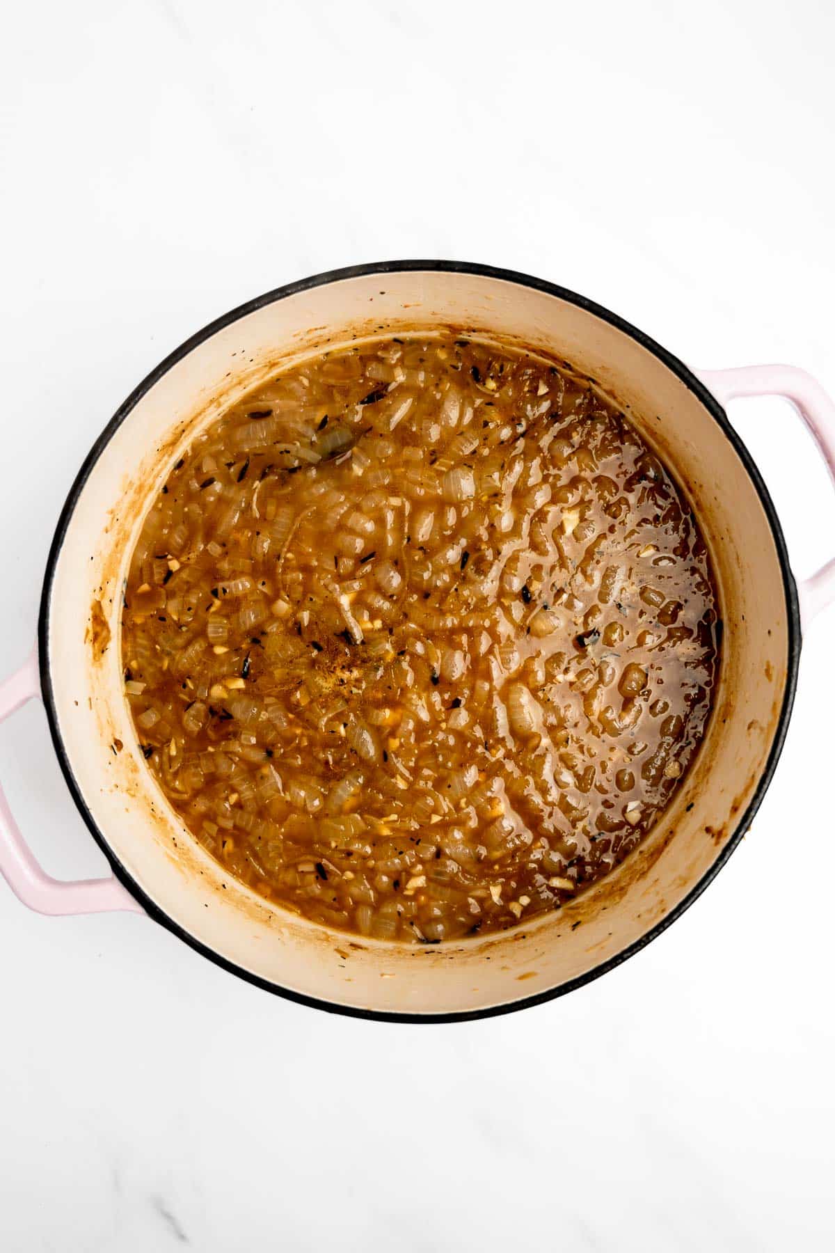 onions and beef broth in a pot.