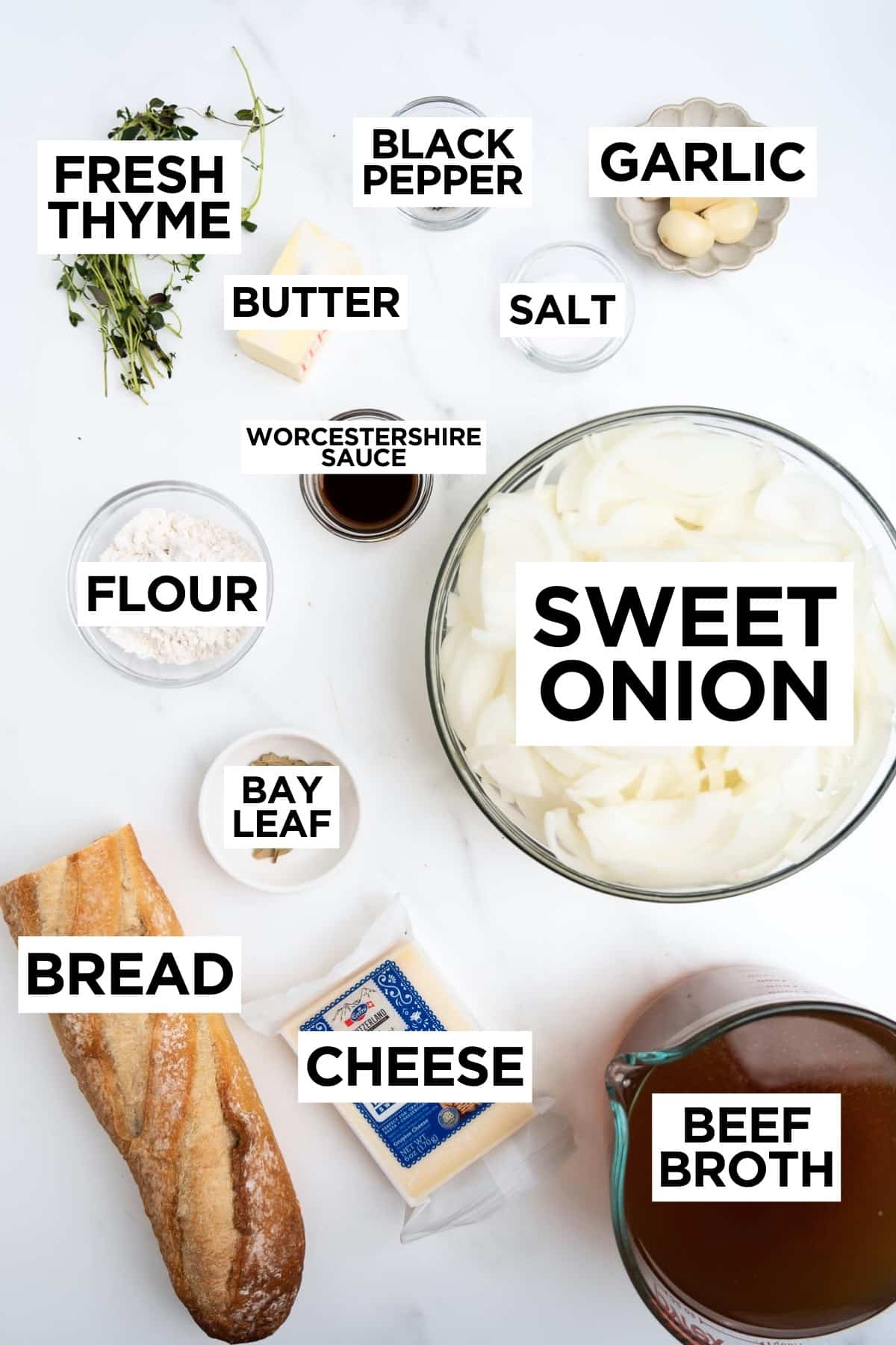 ingredients for French onion soup in bowls with overlay text.