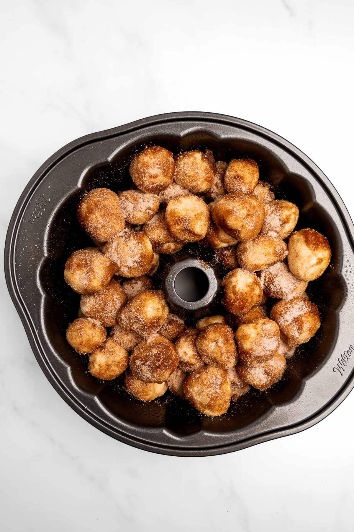 cinnamon sugar dough balls in a Bundt pan.