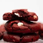 three red velvet cookies stacked.