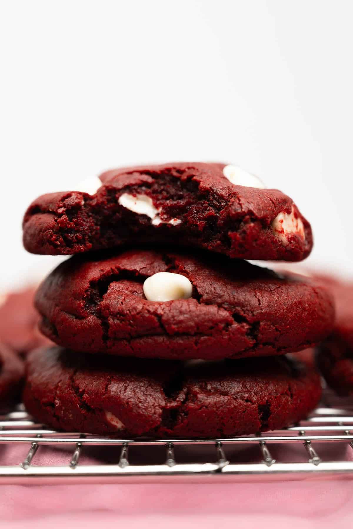 three red velvet cookies stacked.
