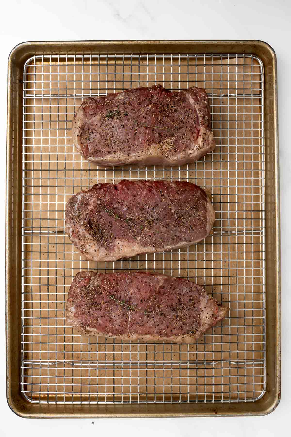 cooked reverse sear steak on baking sheet.