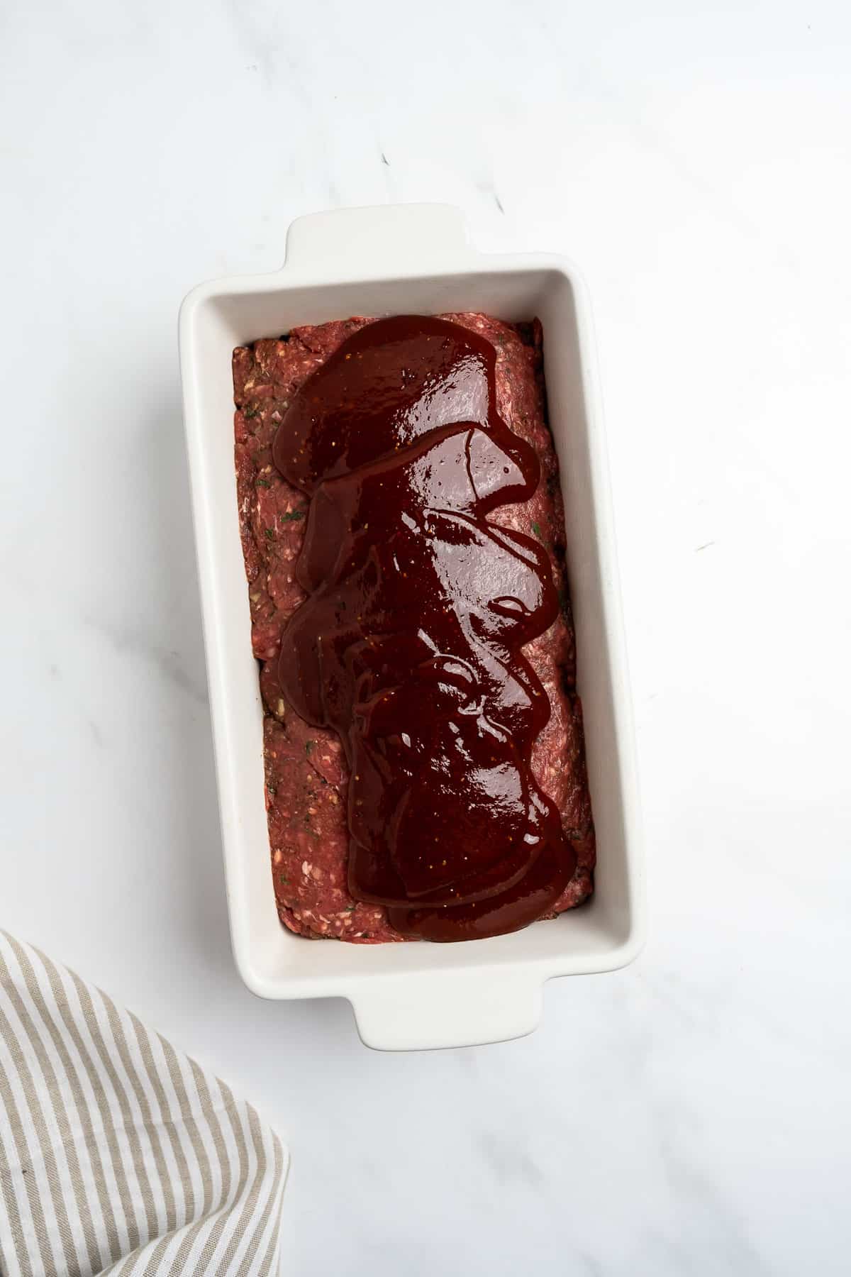 meatloaf in a baking dish topped with glaze.
