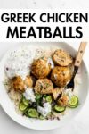 Greek chicken meatballs over rice with cucumber on a white bowl with overlay text.