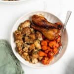 homemade stuffing with turkey legs and carrots on a plate.
