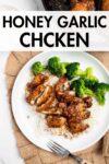 sliced honey garlic chicken thighs over rice with broccoli on a white plate with overlay text.
